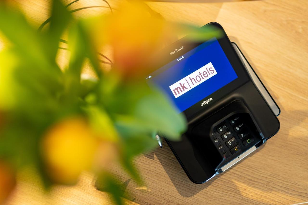 Mk Hotel Tirana Rinas Ngoại thất bức ảnh A mobile phone with the MK1Hotels logo on the screen